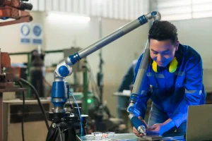 asian-male-engineer-specialist-with-measuring-machine-with-manipulator-armthreedimensional-coordinate-measurement-check-sizes-3d-check-sizes-parts-cmm-after-machining-process