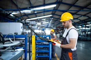 factory-worker-wearing-uniform-hardhat-operating-industrial-machine-with-push-button-joystick-production-hall(1)