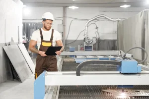 mechanic-standing-near-cnc-controlling-cutting-plasma